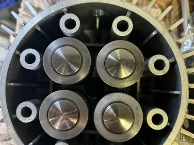 Close-up of new pump pistons installed during servicing of a Nilfisk SH Truck Booster, showing clean surfaces ready for reliable operation.